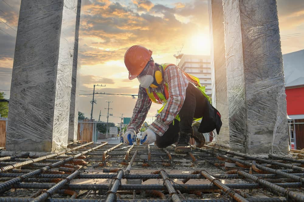 Worker With Contruction Iron Lines For Building Foundation